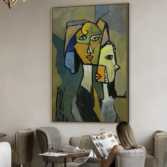 a large abstract painting hanging on a wall, with a woman sitting in a chair and reading a book in front of it.