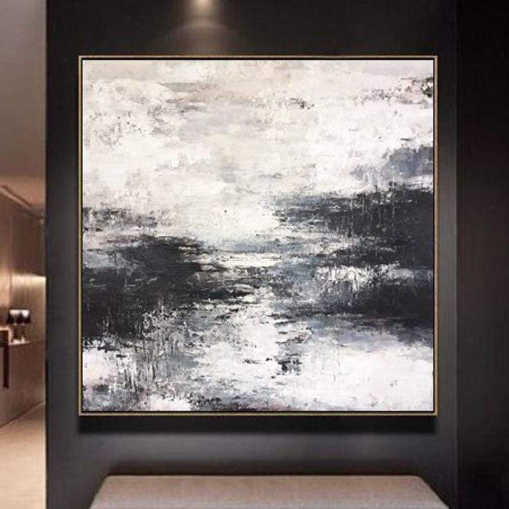 a black and white painting hanging on a wall