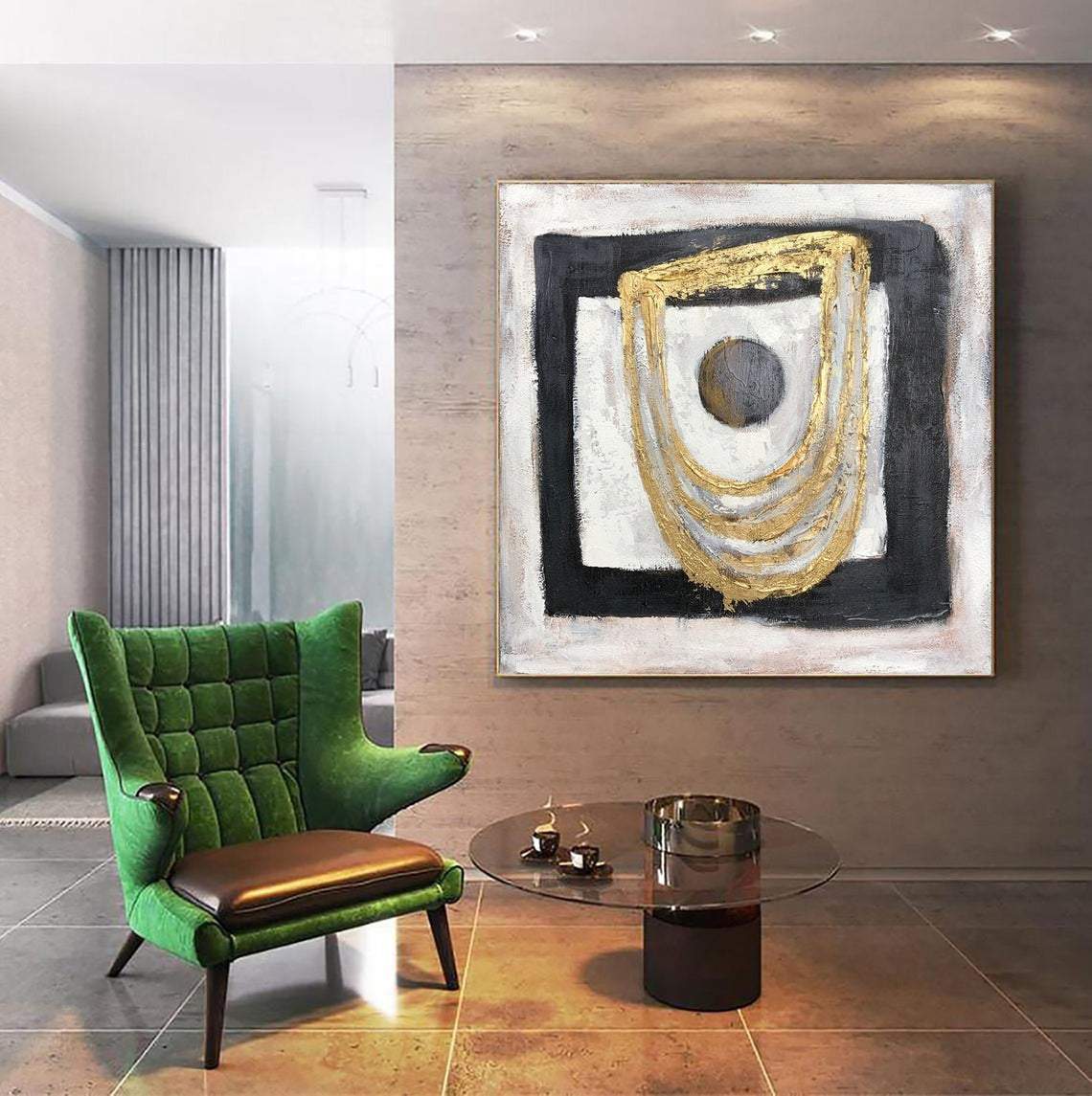 a green chair sitting in front of a painting on a wall