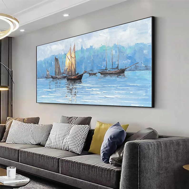 a living room filled with furniture and a painting on the wall