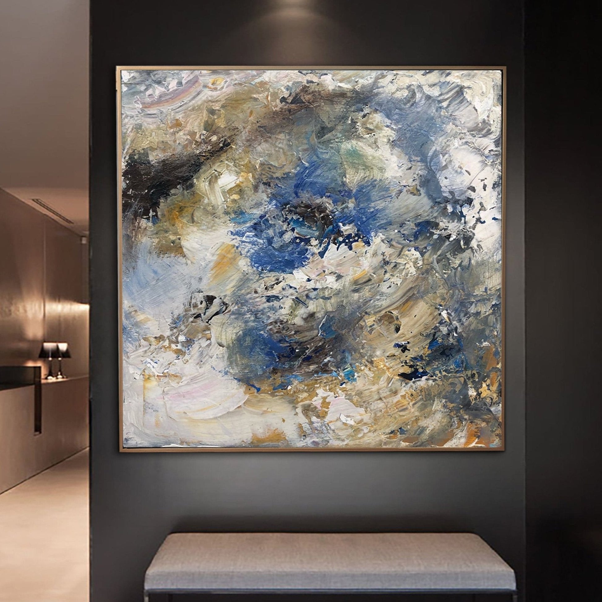 a large abstract painting hanging on a wall, with a black and white color scheme.