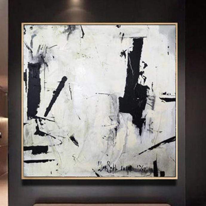 a black and white painting hanging on a wall