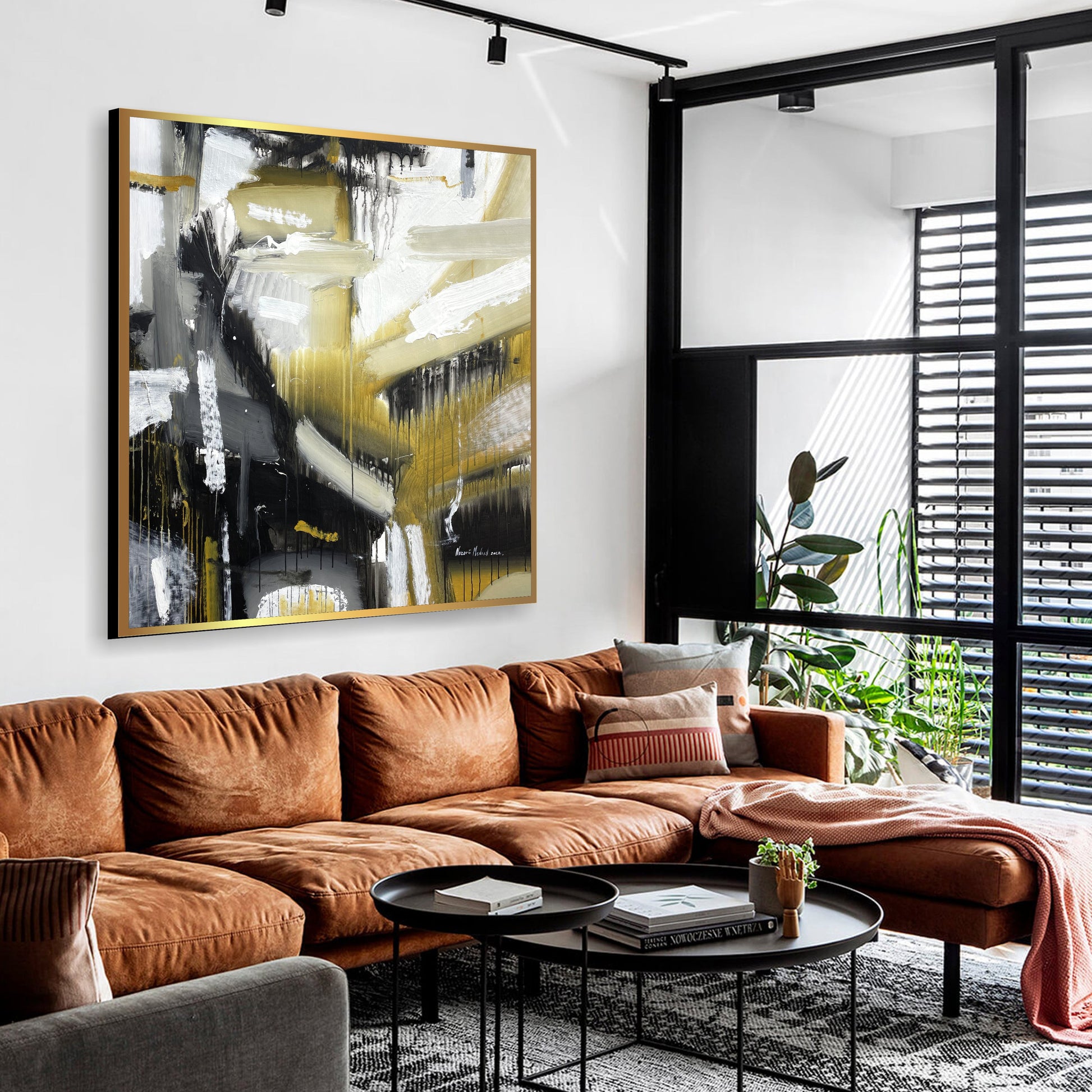 a living room filled with furniture and a large painting