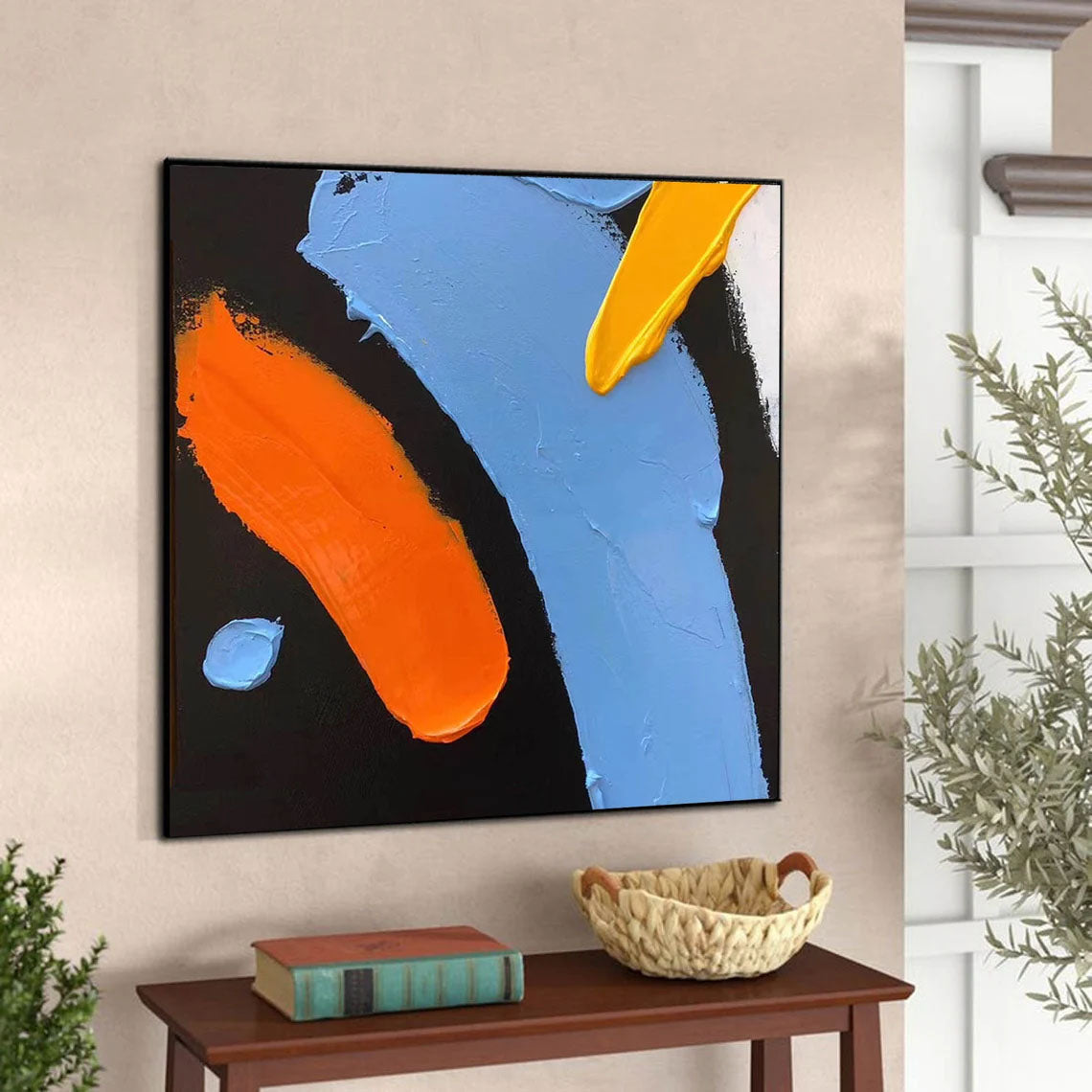 a painting hanging on a wall next to a table