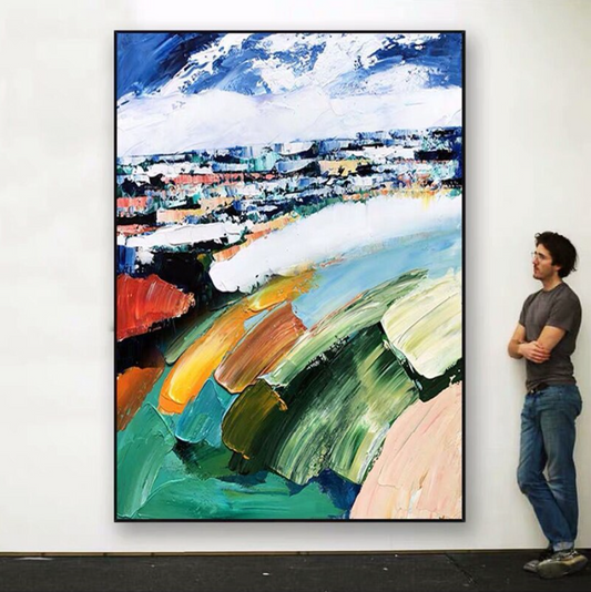 a man standing next to a painting on a wall