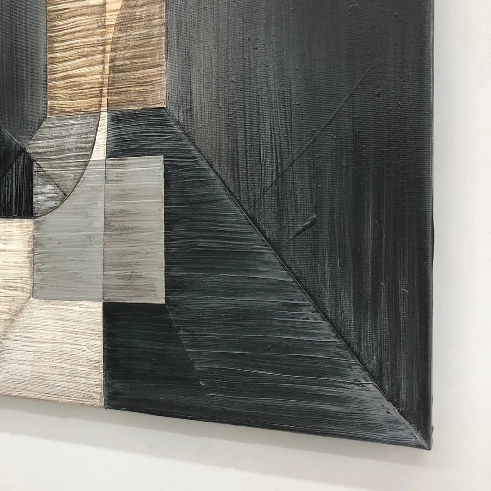 The image is a close-up of a black and white abstract artwork, featuring a geometric pattern with various shades of gray and black.