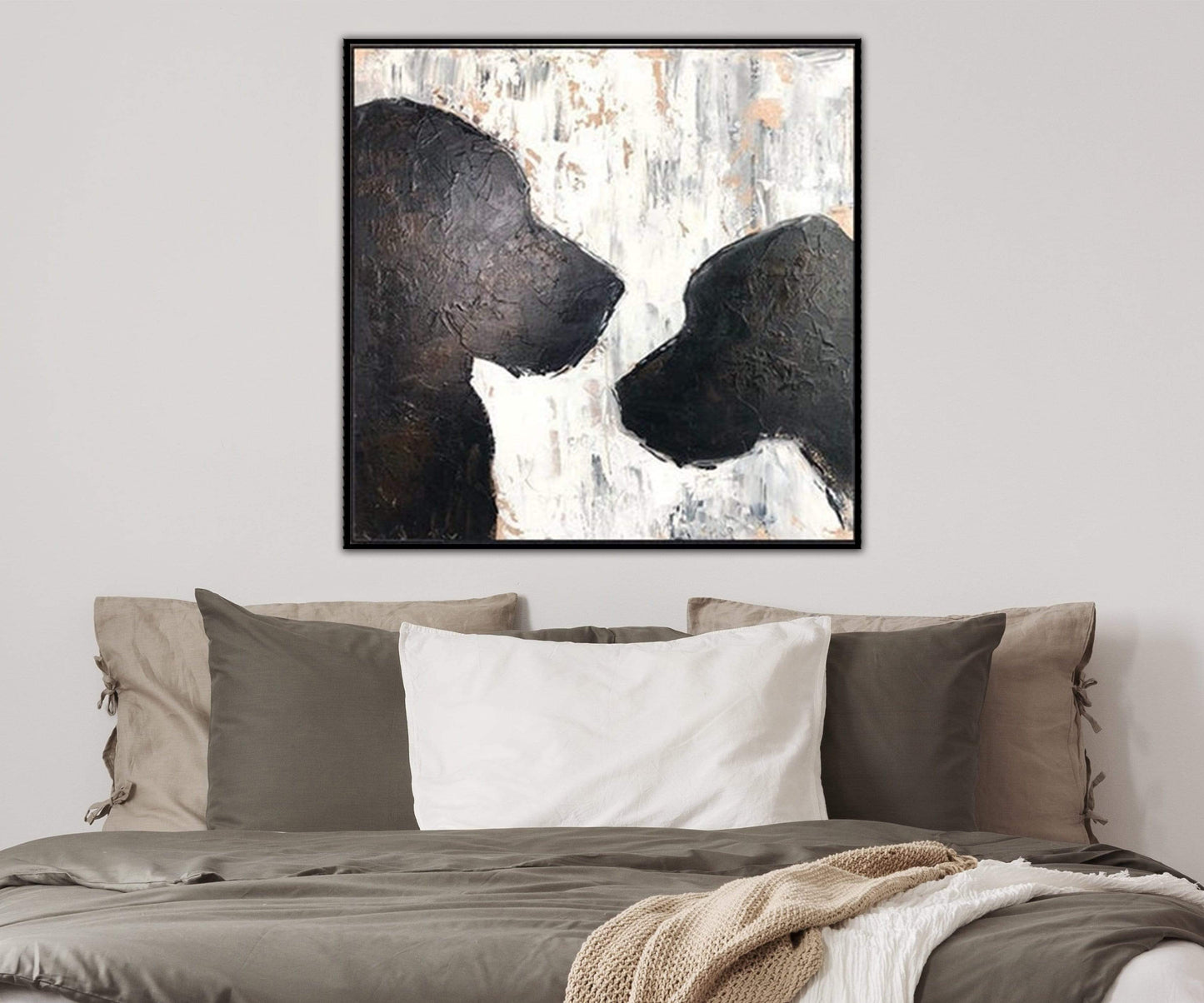 a painting of two black dogs on a white wall above a bed