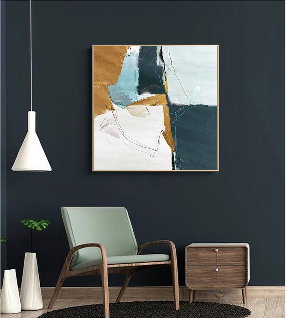 a living room with a chair and a painting on the wall