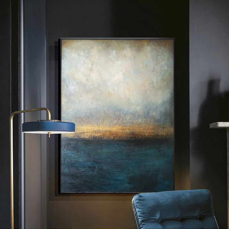 a painting hanging on a wall next to a blue chair