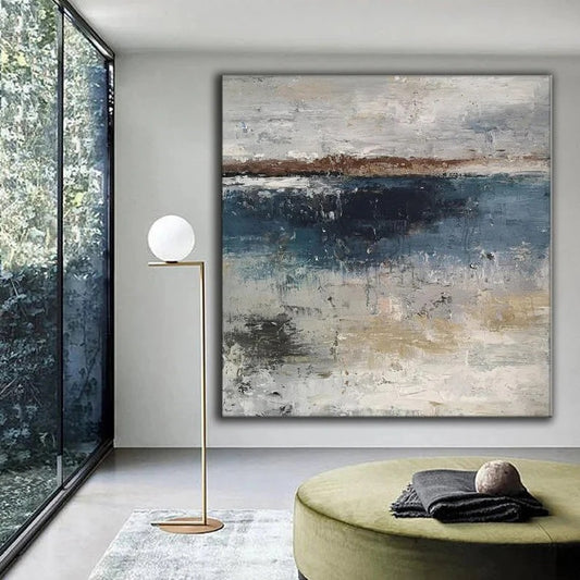 a modern living room with a large abstract painting on the wall, a floor lamp, and a round green ottoman with a black blanket on it.
