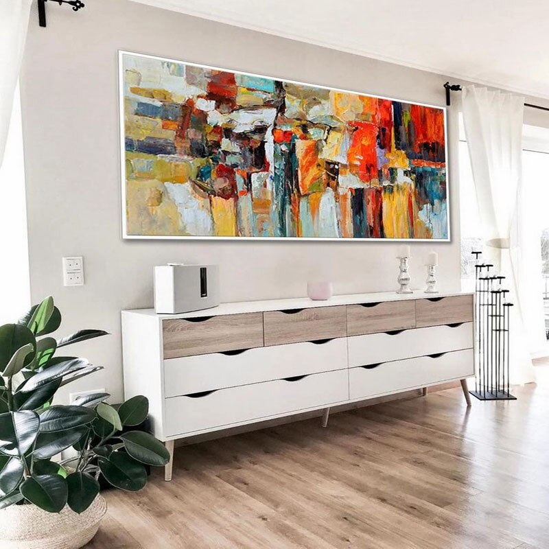 a living room with a large painting on the wall