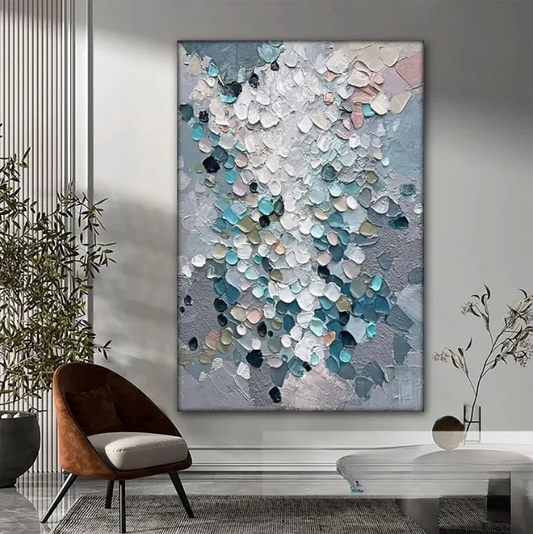 a large abstract painting with a textured, colorful design hanging on a wall in a modern living room setting.