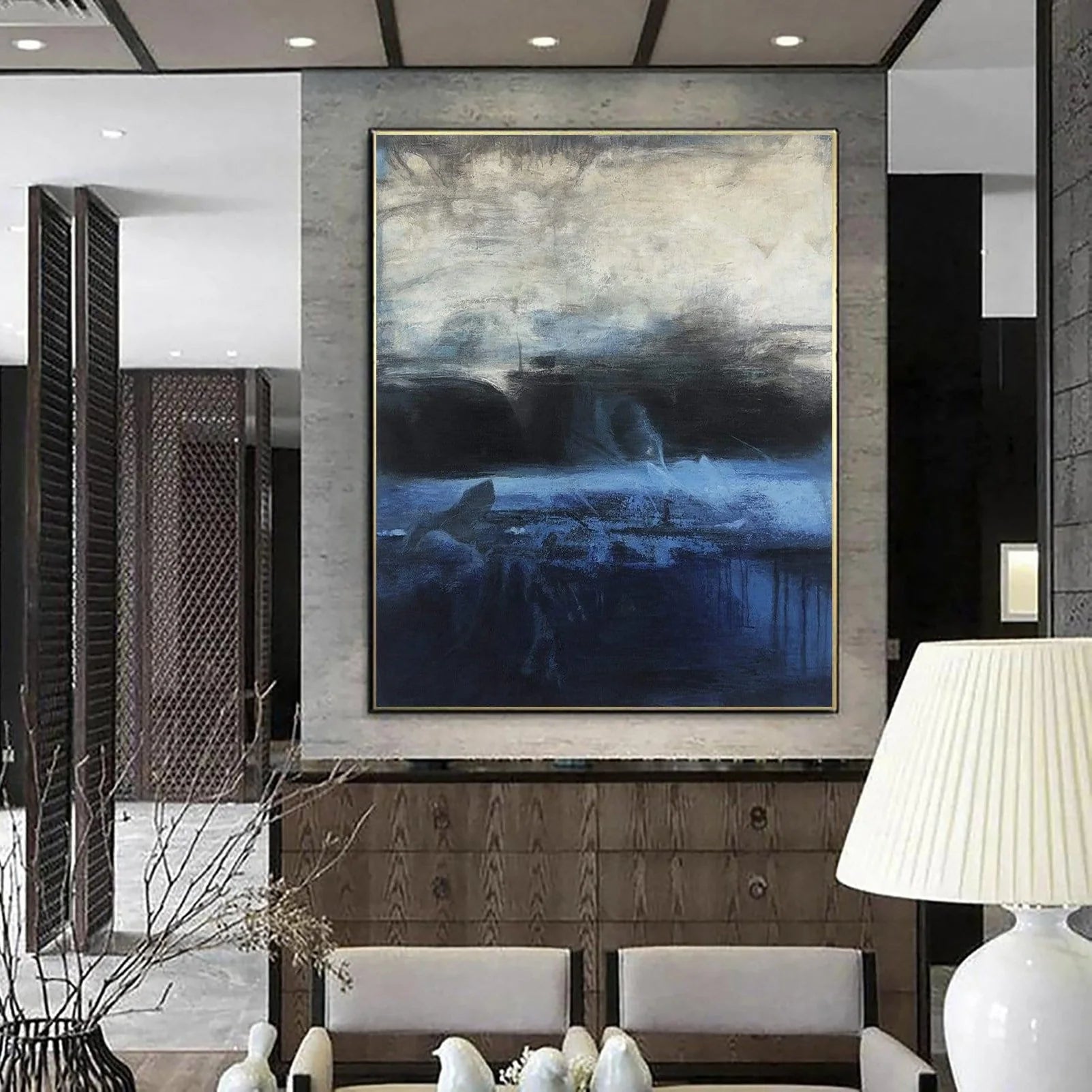 a large abstract painting hanging on a wall in a modern living room.