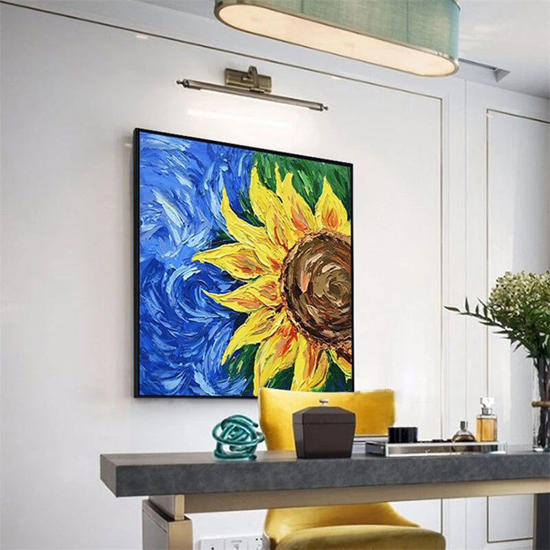a painting of a sunflower on a wall above a table
