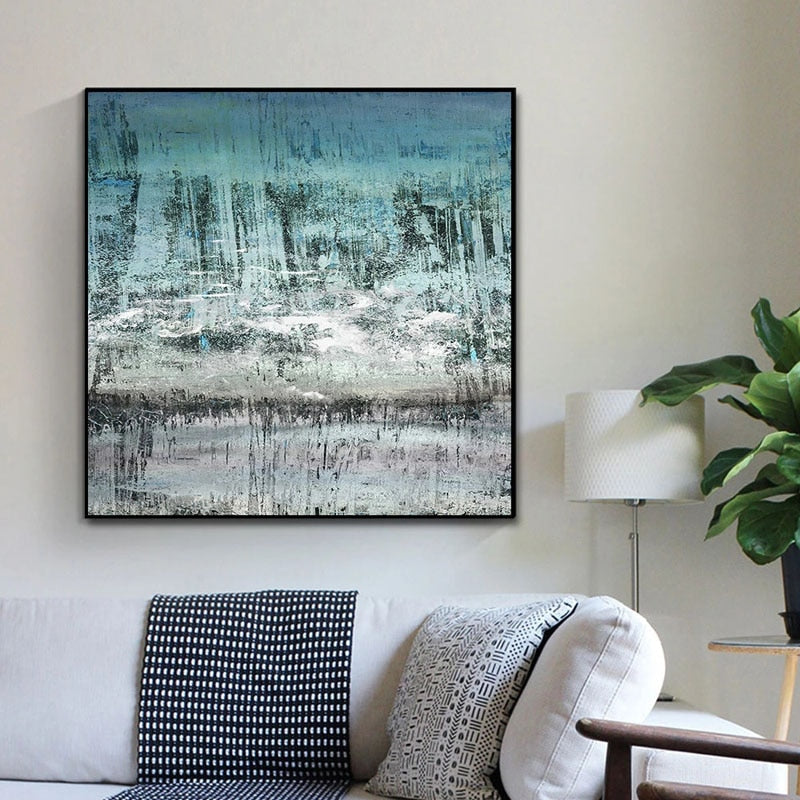 a living room with a couch and a painting on the wall