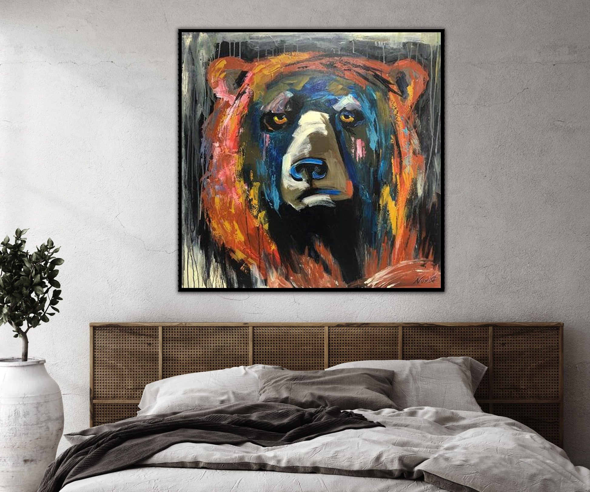 a painting of a bear on a wall above a bed