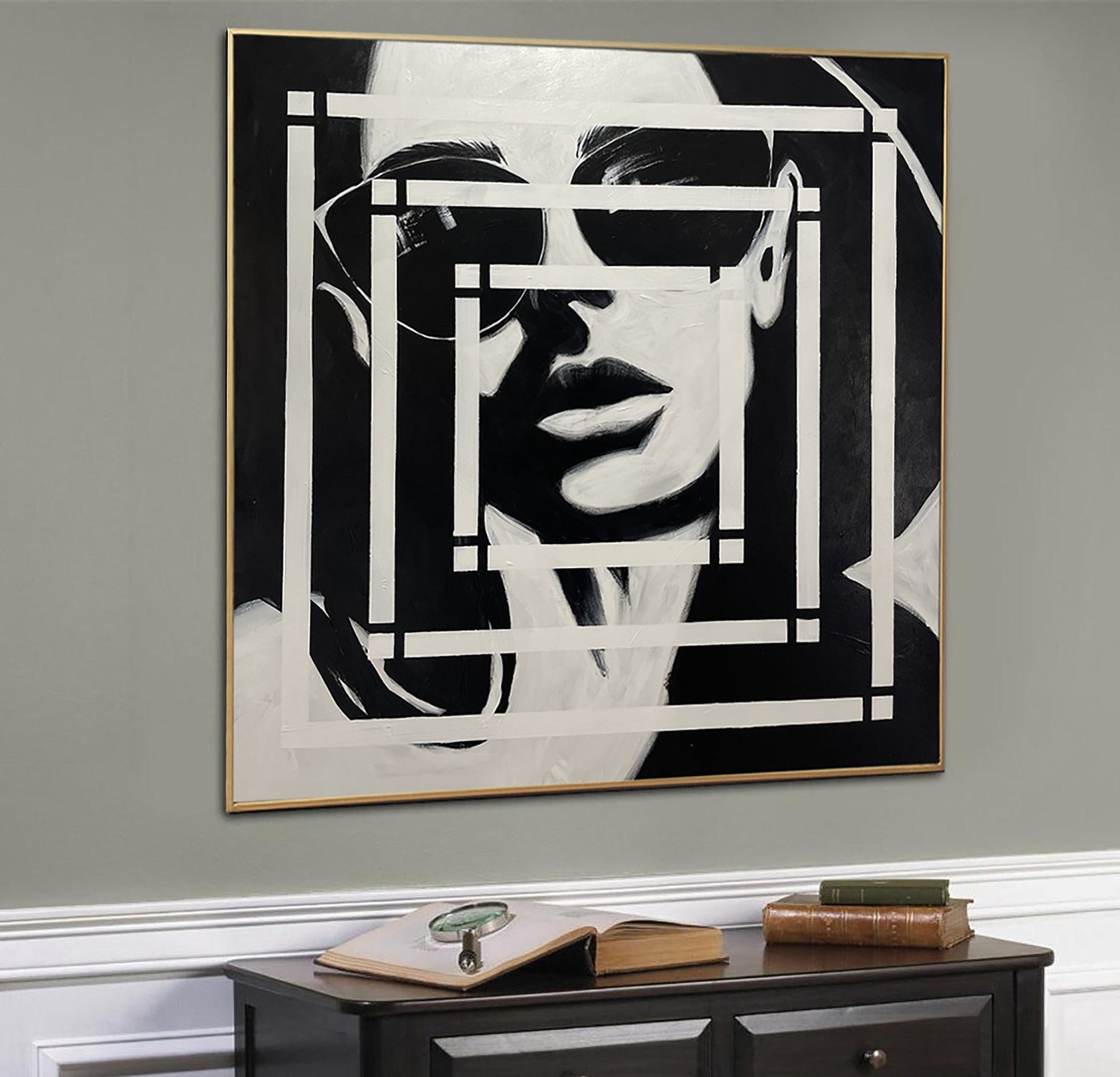 a black and white painting hanging on a wall