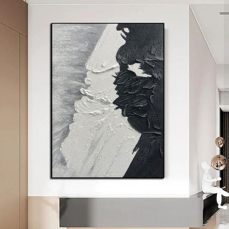 a black and white painting hanging on a wall