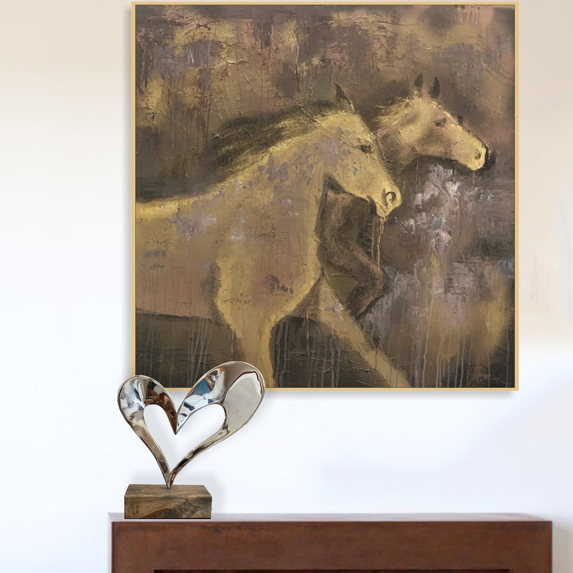 a painting of two horses on a white wall