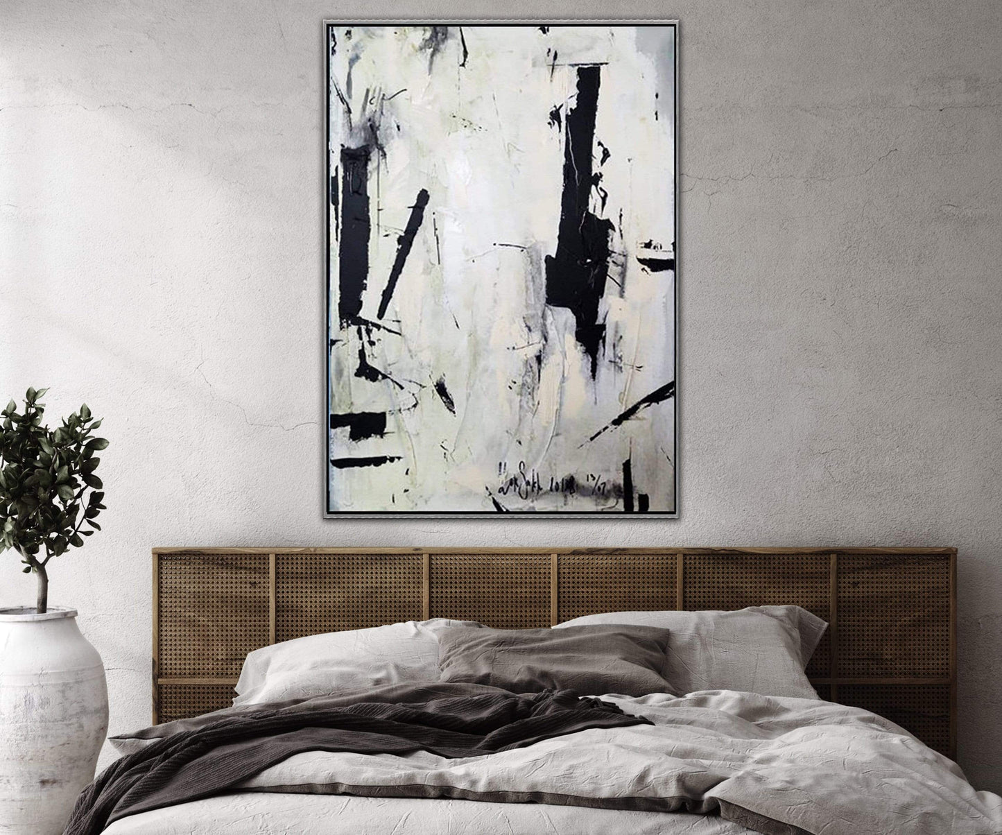 a painting hanging above a bed in a bedroom