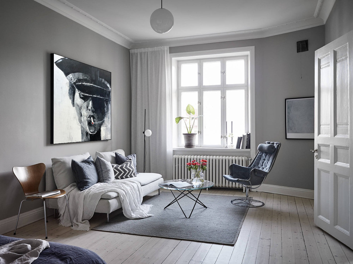 a living room filled with furniture and a painting on the wall