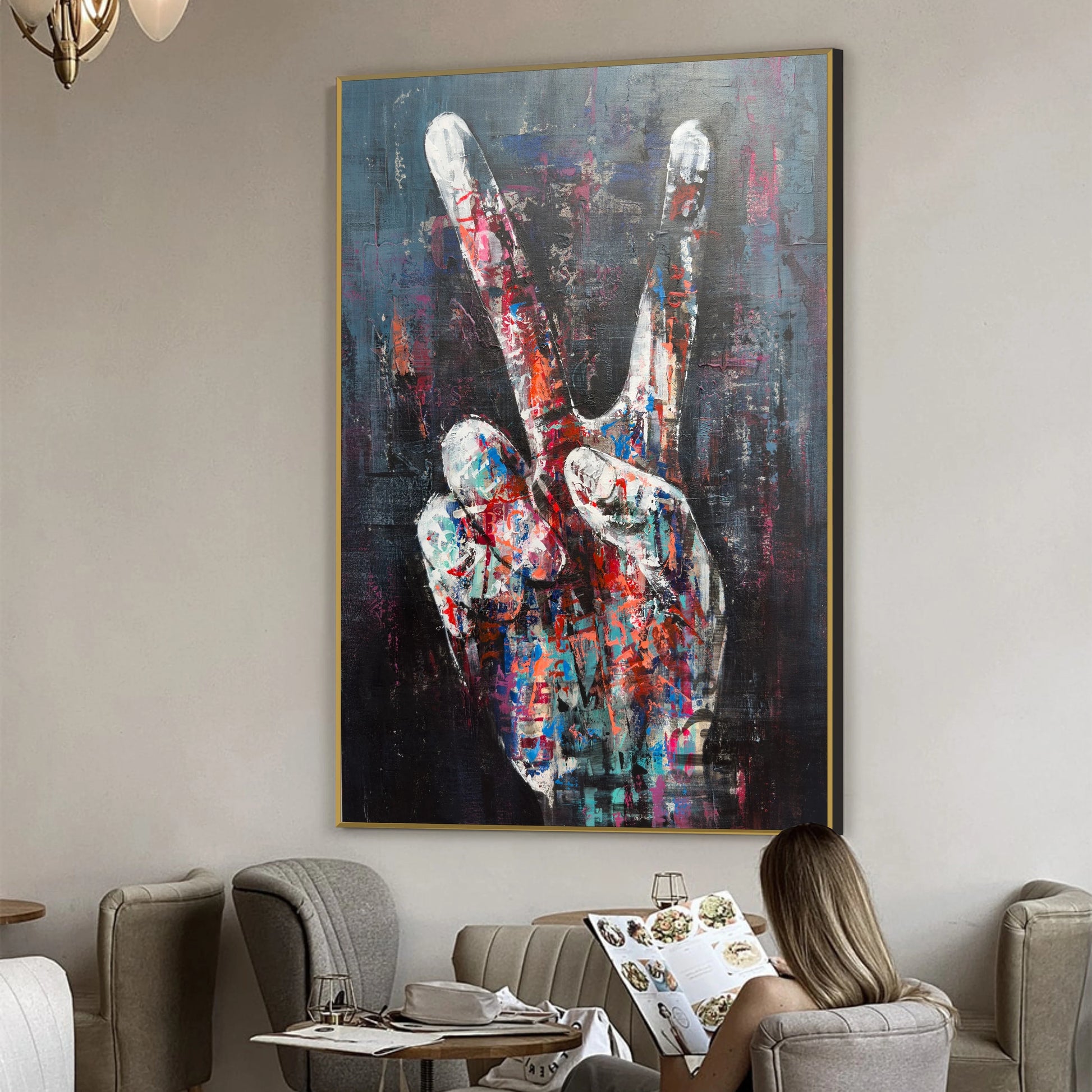 a large, colorful painting of a hand making a peace sign on the wall of a room.