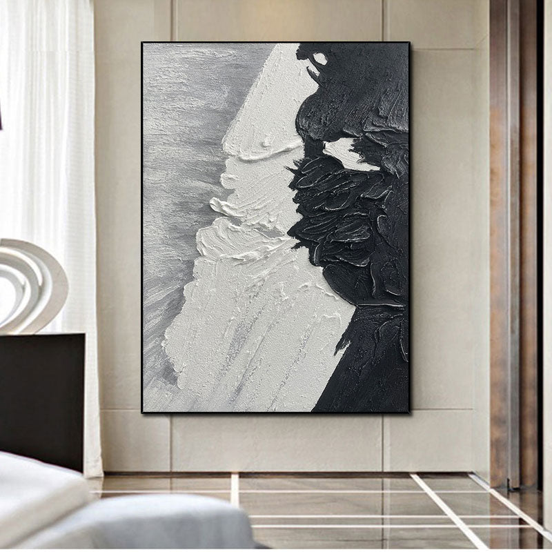 a black and white painting hanging on a wall