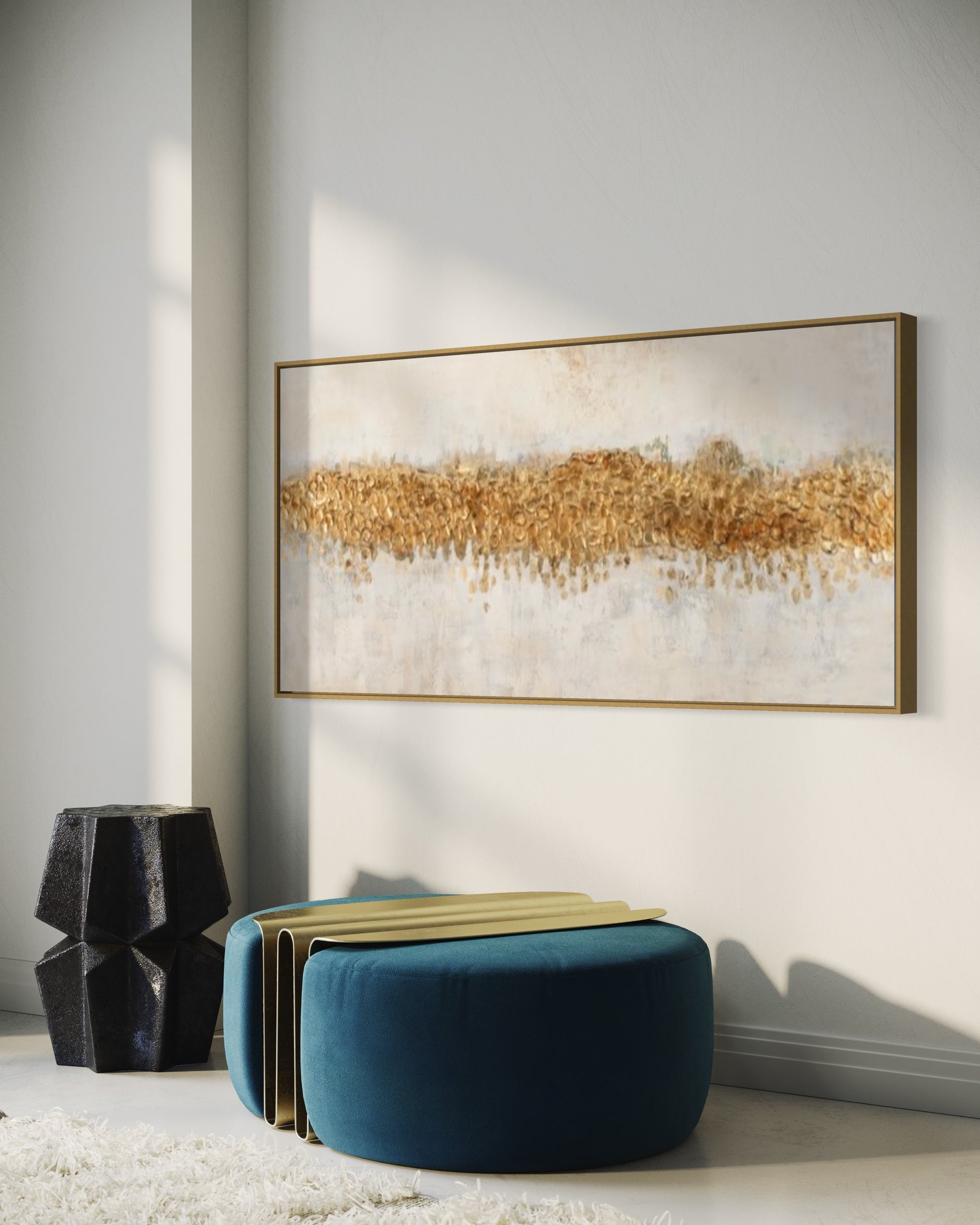 a living room with a blue ottoman and a painting on the wall