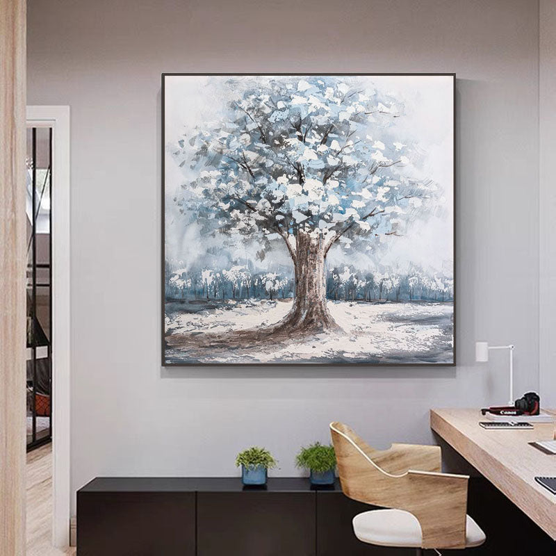 a painting of a tree on a wall above a desk