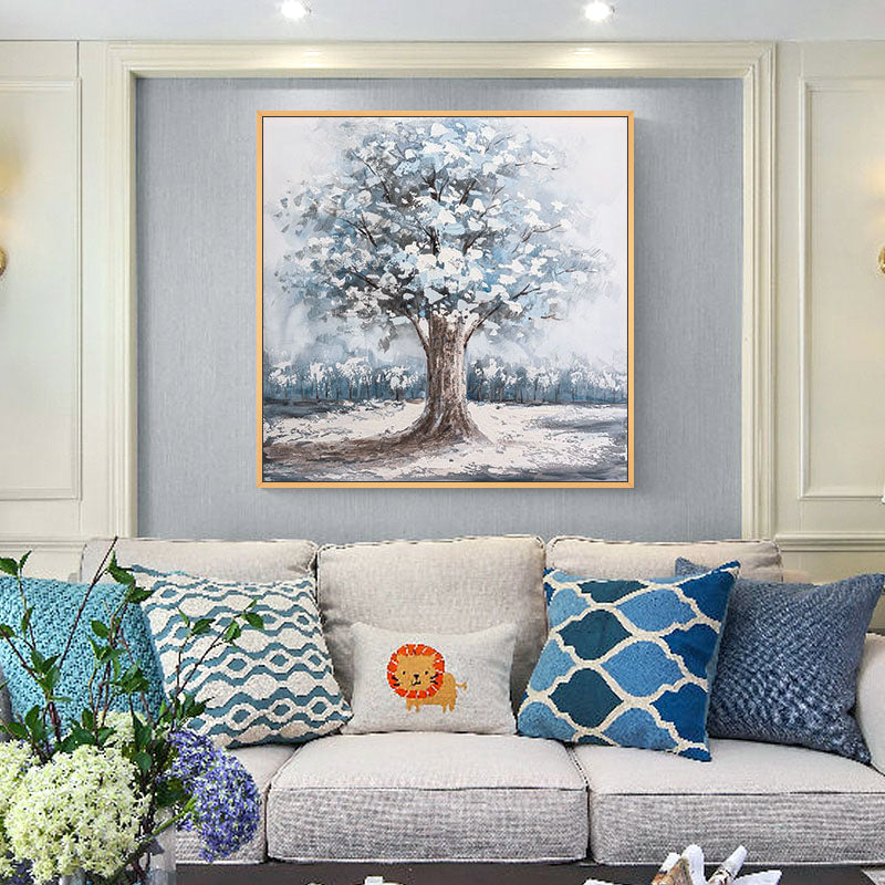 a living room with a couch and a painting on the wall