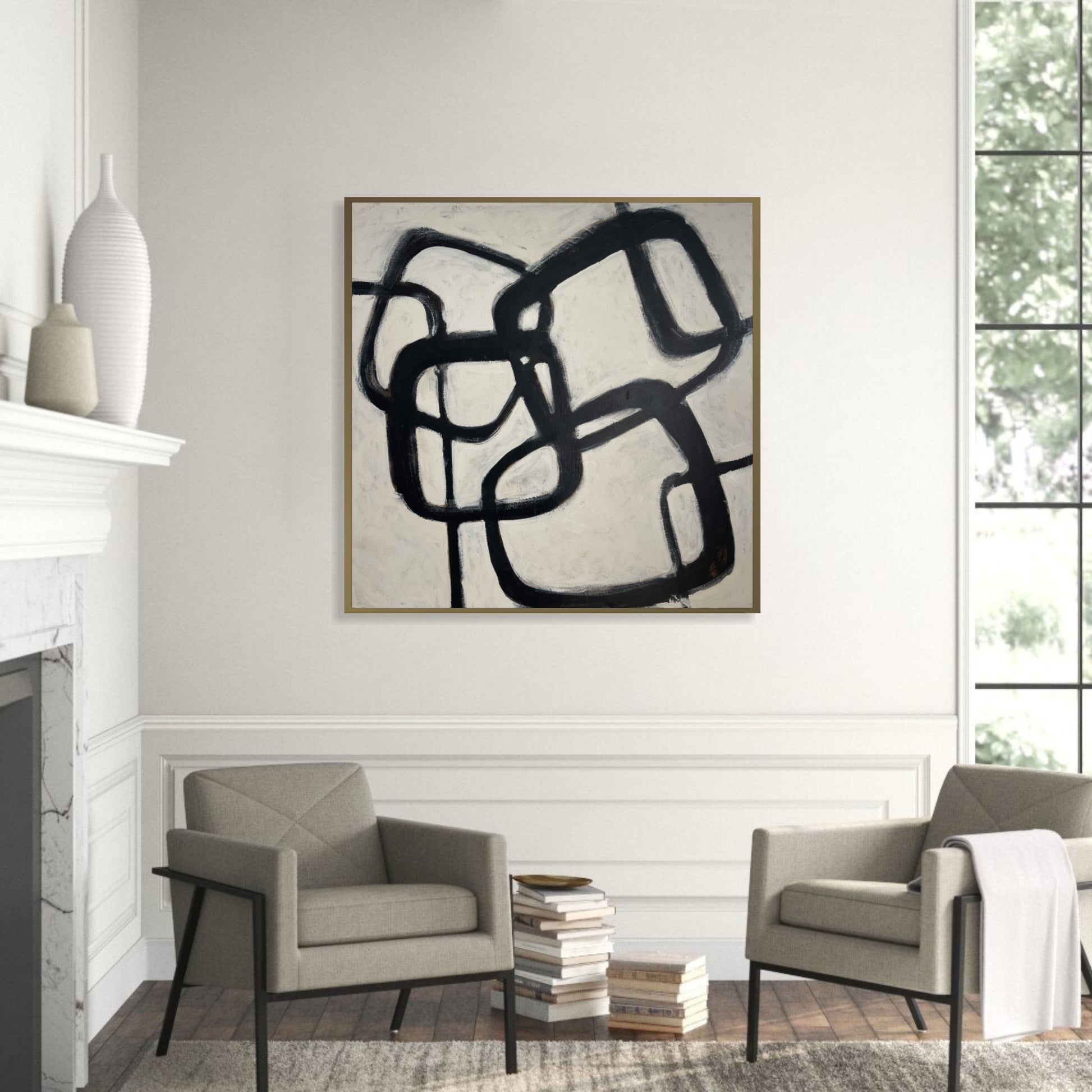 a living room with two chairs and a painting on the wall