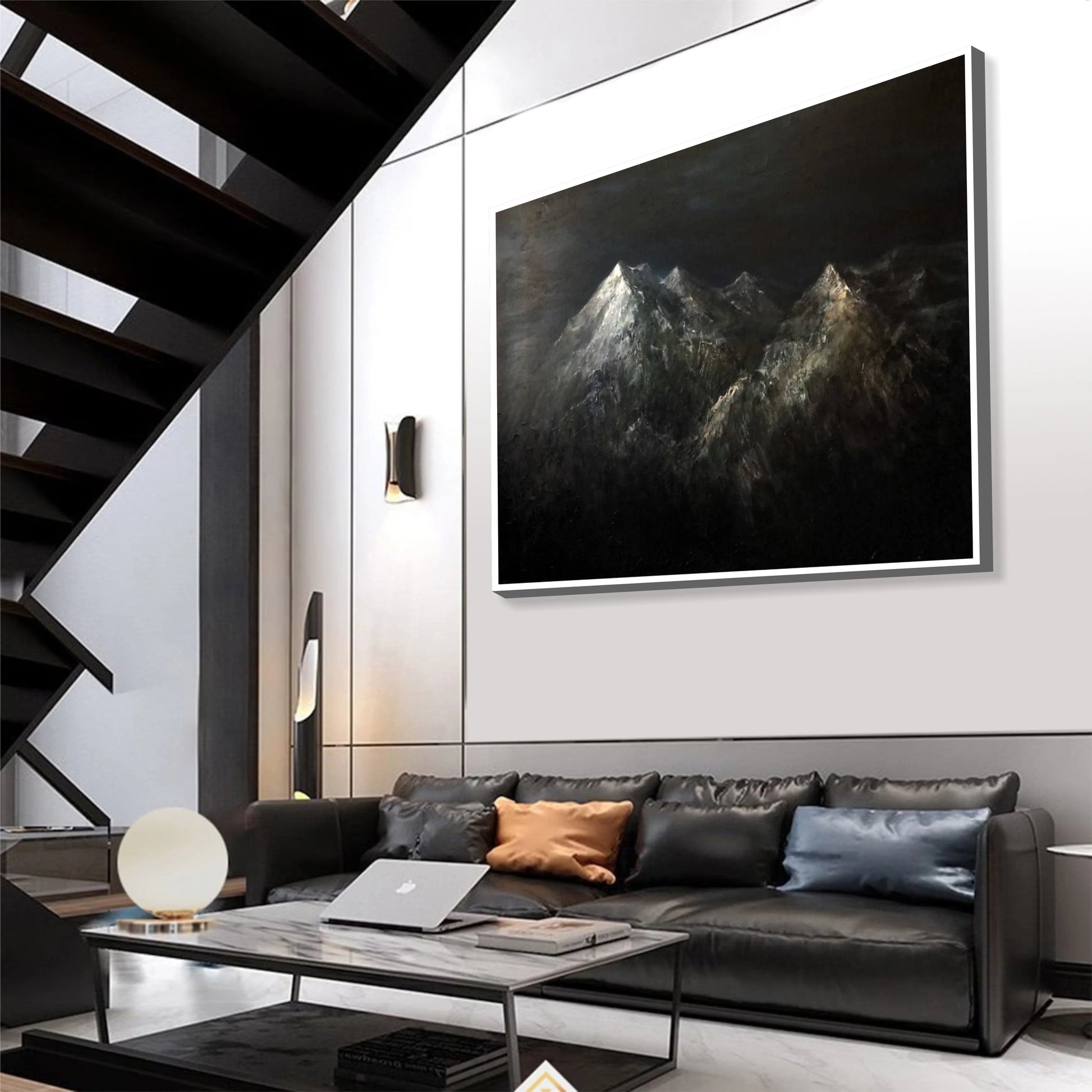 a modern living room with a large black and white painting of mountains hanging on the wall above a black leather sofa. The room has a sleek, minimalist design with a black staircase and a glass coffee table in the center.