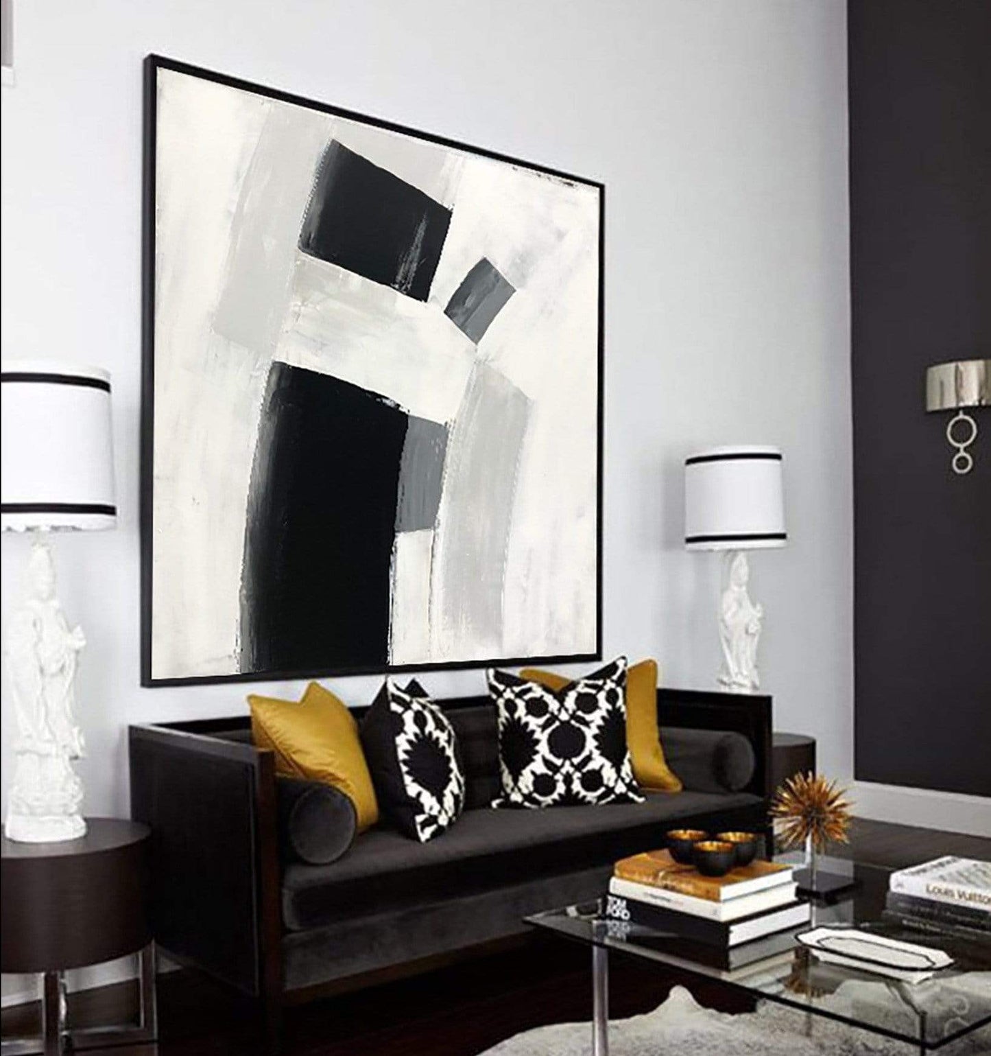 a black and white living room with a painting on the wall