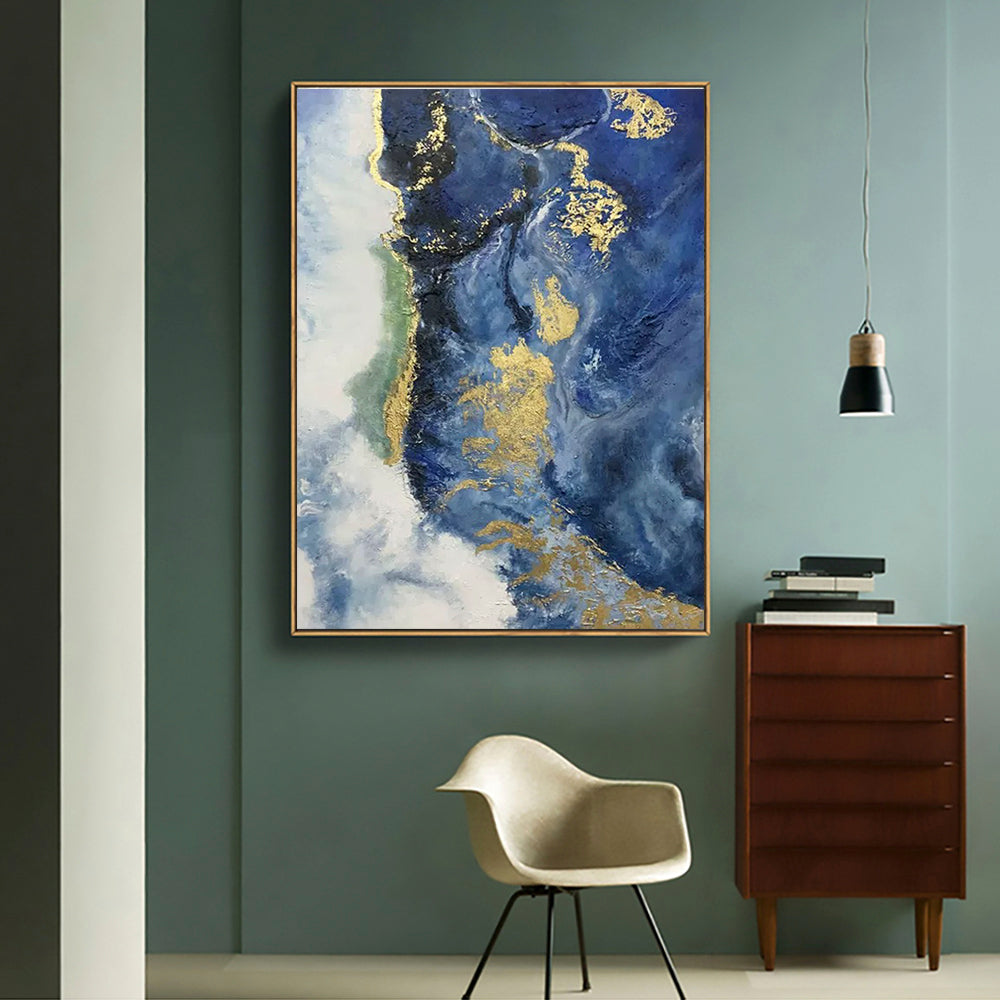 a painting hanging on a wall next to a chair