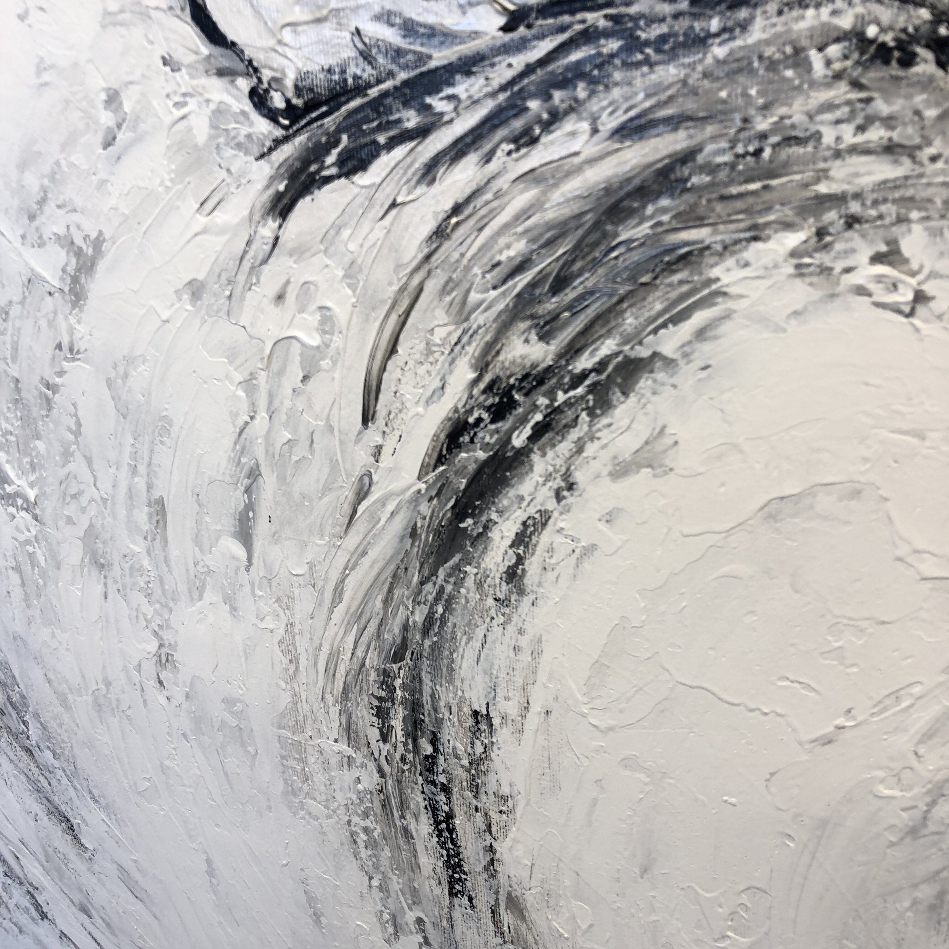 a close up of a white and black abstract painting