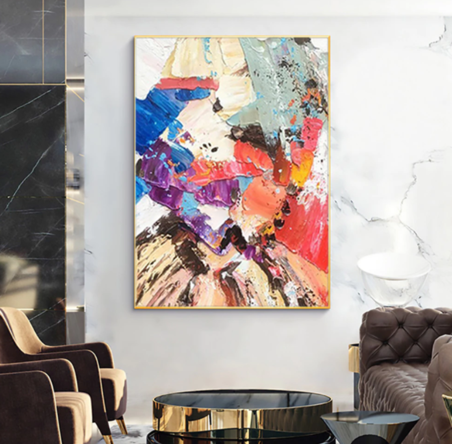 a living room filled with furniture and a painting on the wall