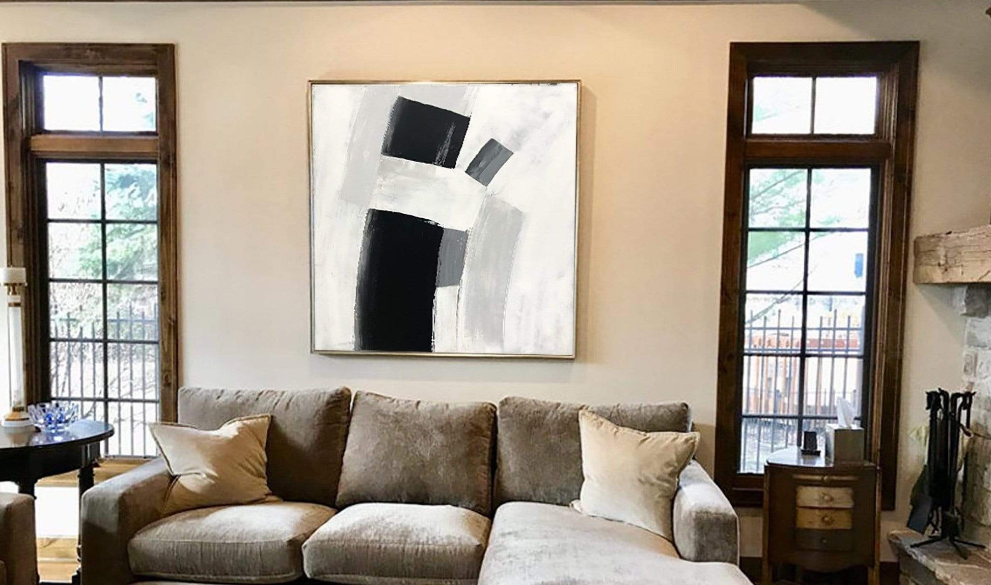 a living room filled with furniture and a painting on the wall