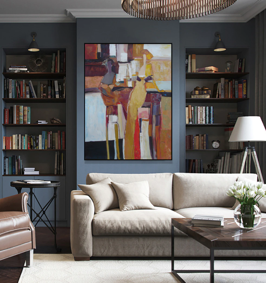 a living room filled with furniture and a painting on the wall