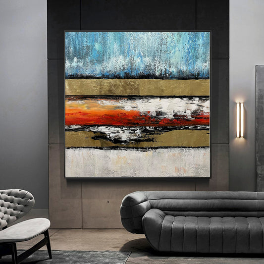 a living room with a couch and a painting on the wall