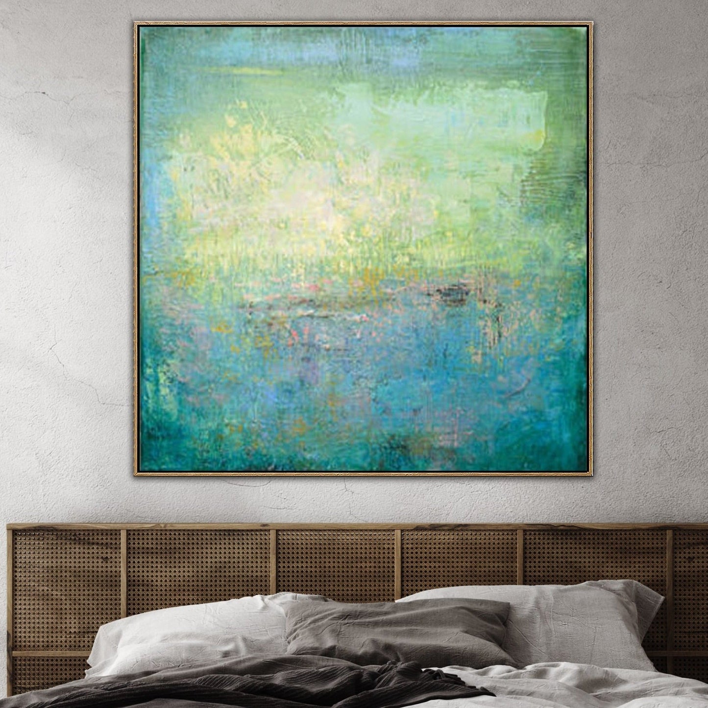 a large abstract painting hanging on a wall above a bed with a wooden headboard.