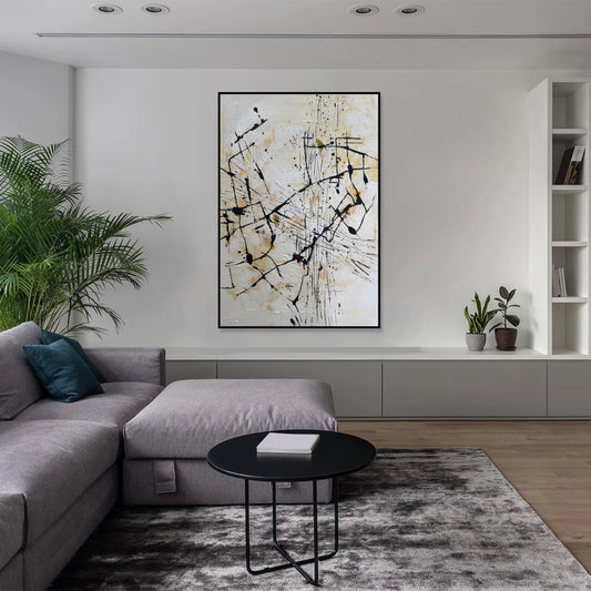a modern living room with a gray sectional sofa, a black coffee table, and a large abstract painting on the wall.