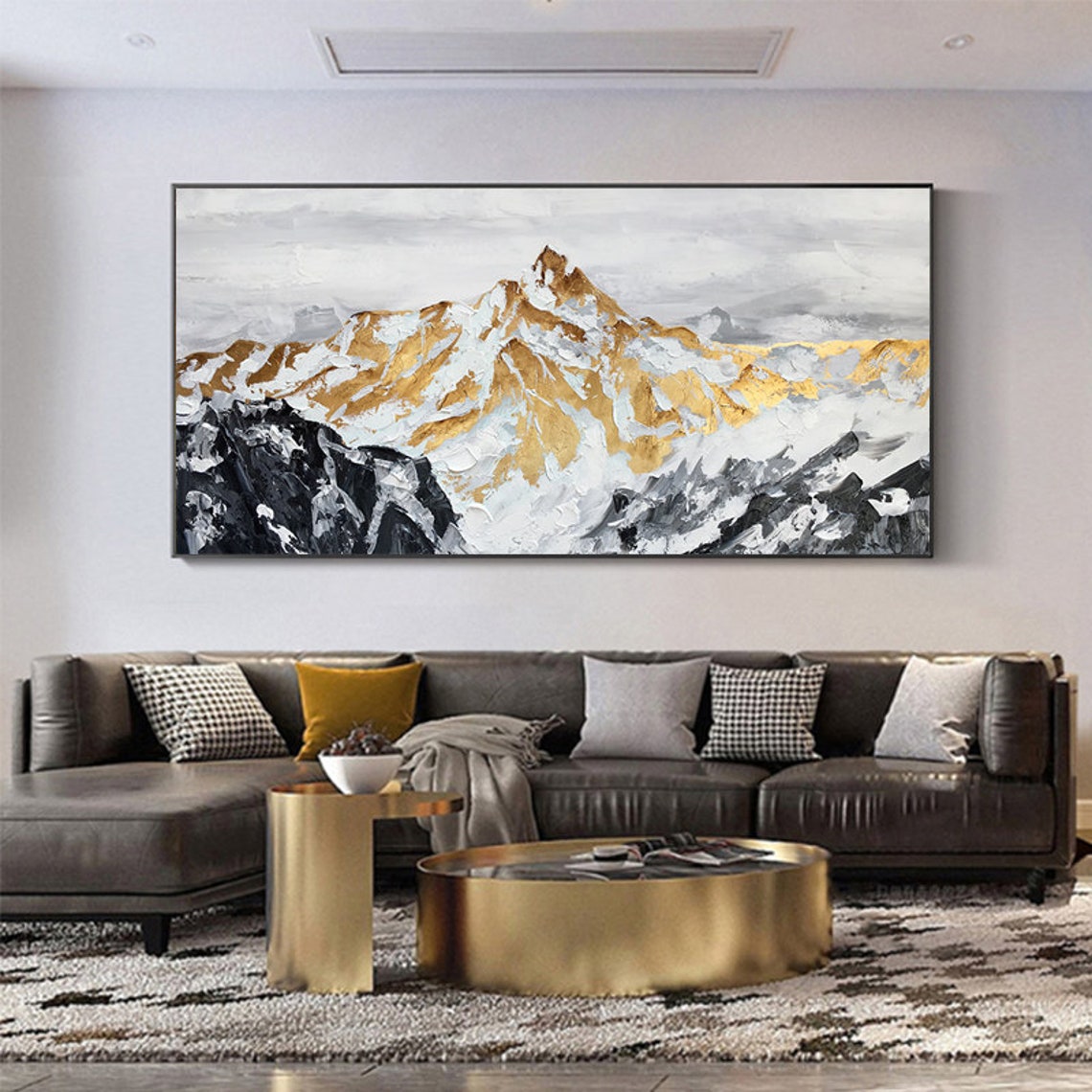 a living room with a large painting on the wall