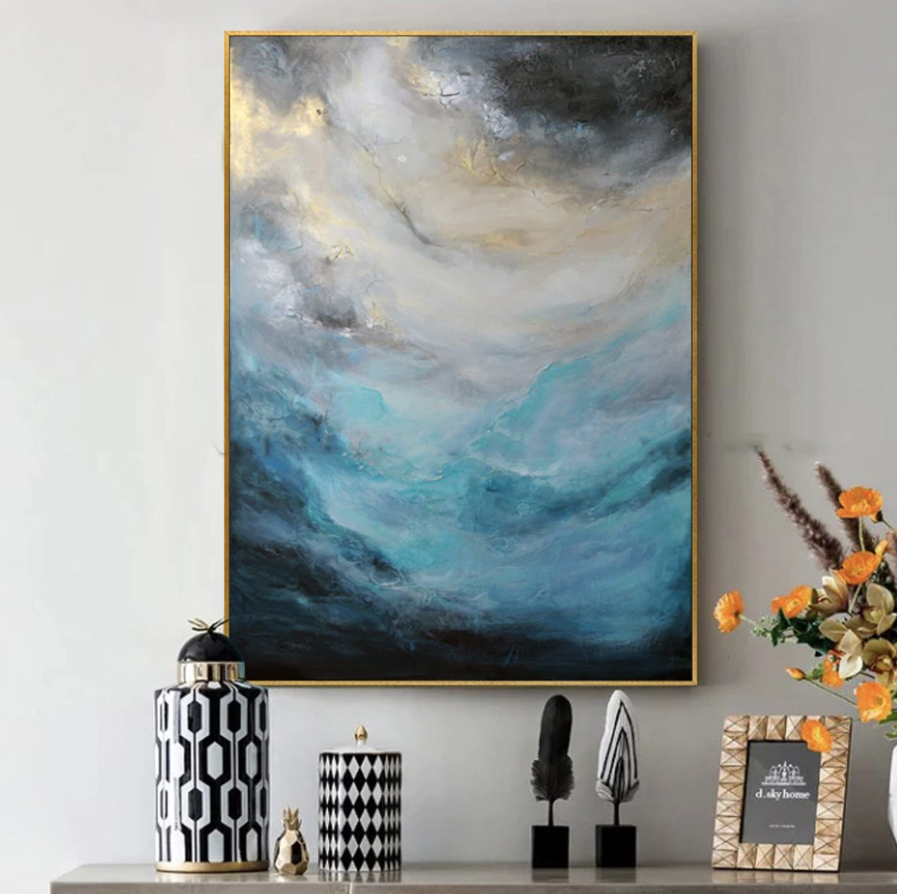 a painting hanging on a wall above a shelf