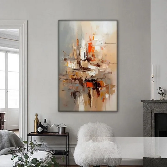 a large abstract painting hanging on a wall in a living room. The painting has a mix of warm and cool colors, creating a vibrant and dynamic visual effect. The room is decorated with a white fur rug, a wooden side table, and a white chair. There are also some bottles and a vase on the side table, adding to the cozy and inviting atmosphere of the space.