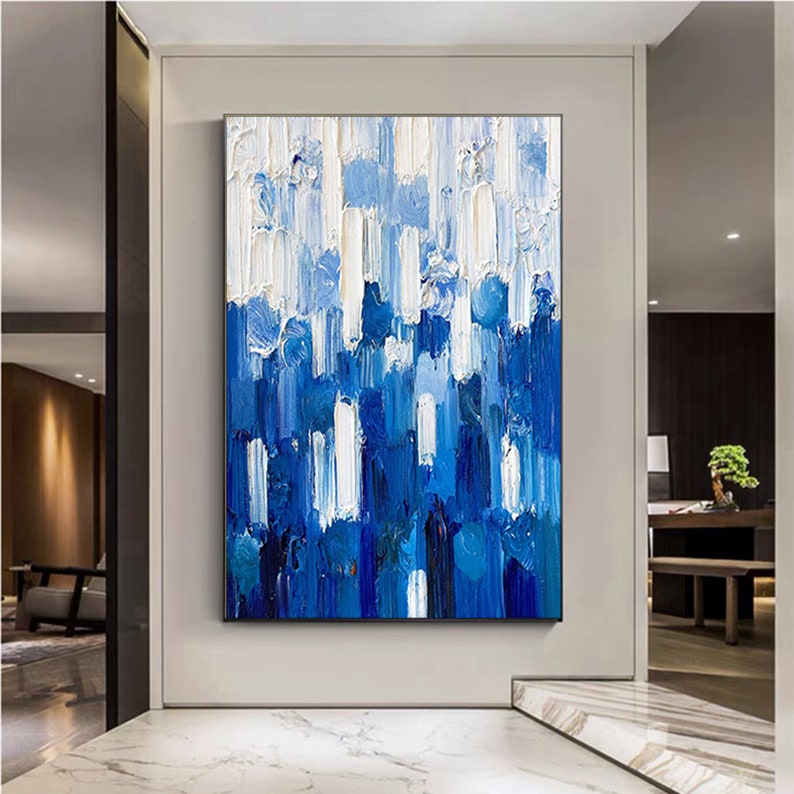 a painting of blue and white on a wall