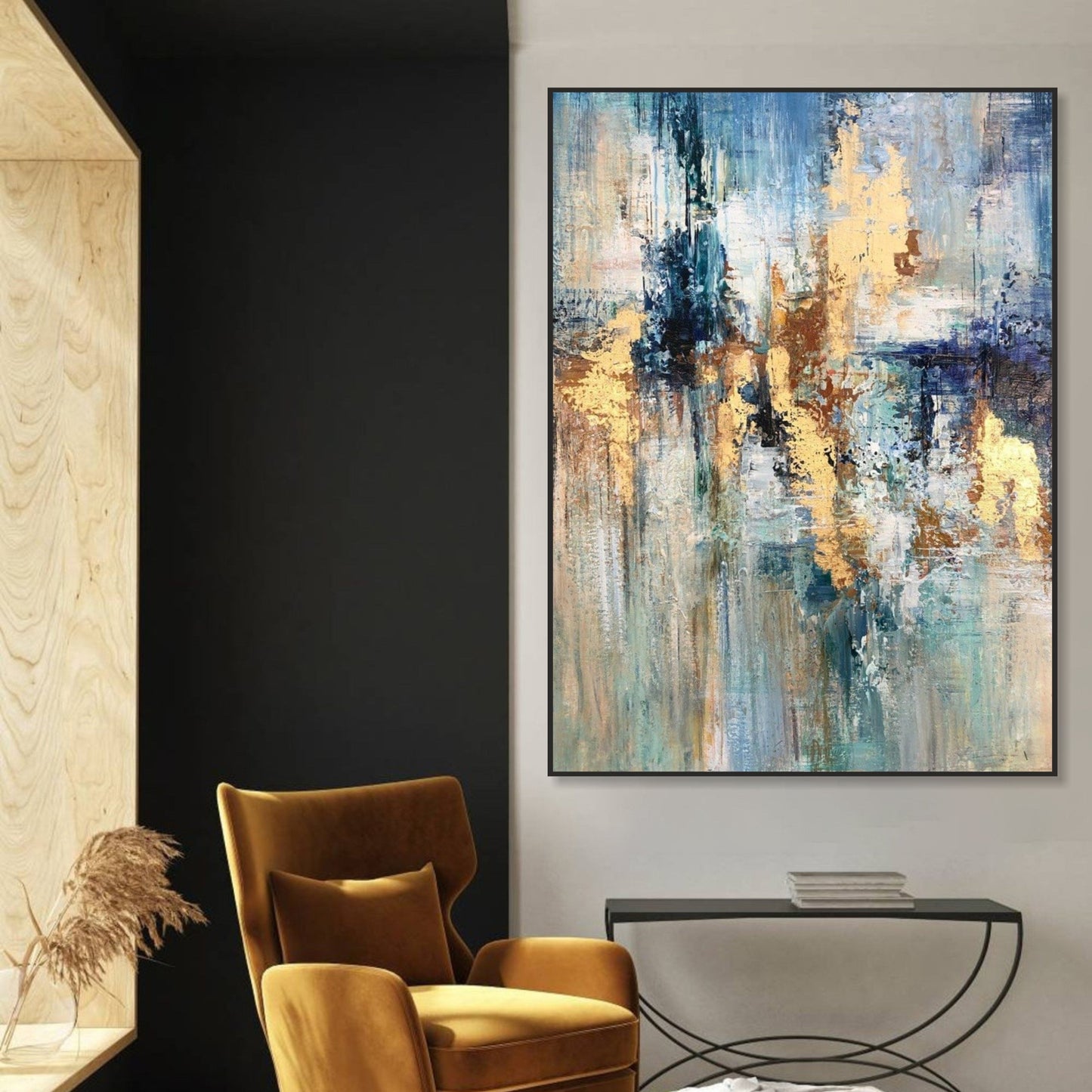a modern living room with a large abstract painting hanging on the wall, a black armchair, and a small side table with a plant.