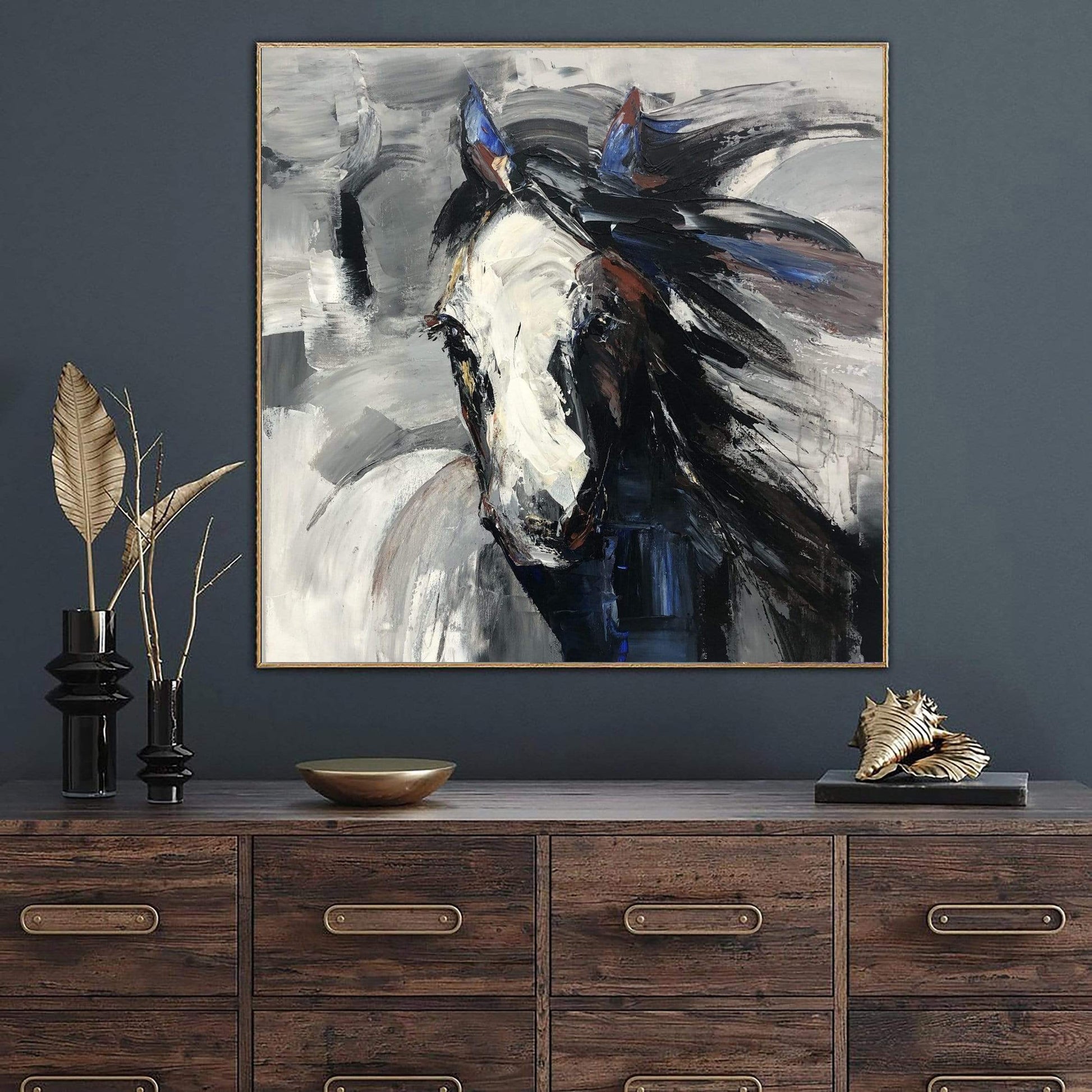 a painting of a horse on a wall above a dresser