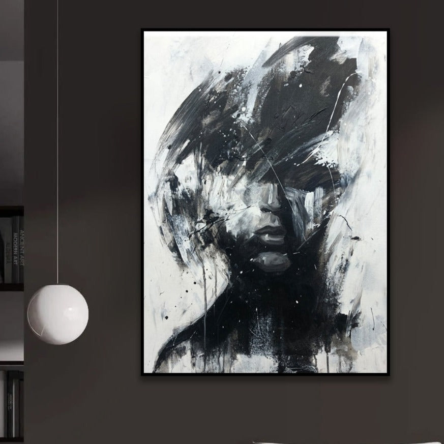 a black and white painting hanging on a wall