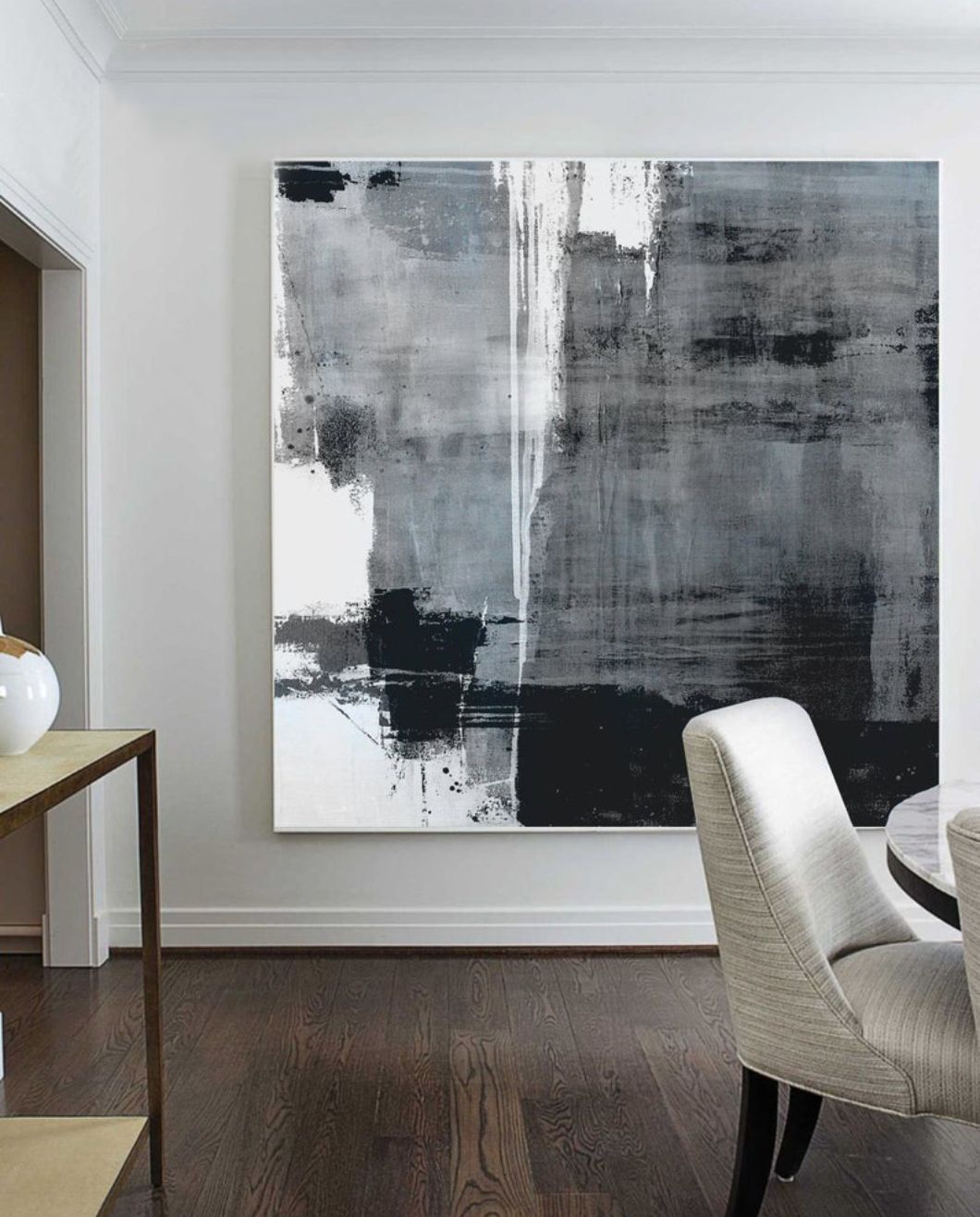 a large black and white painting in a dining room