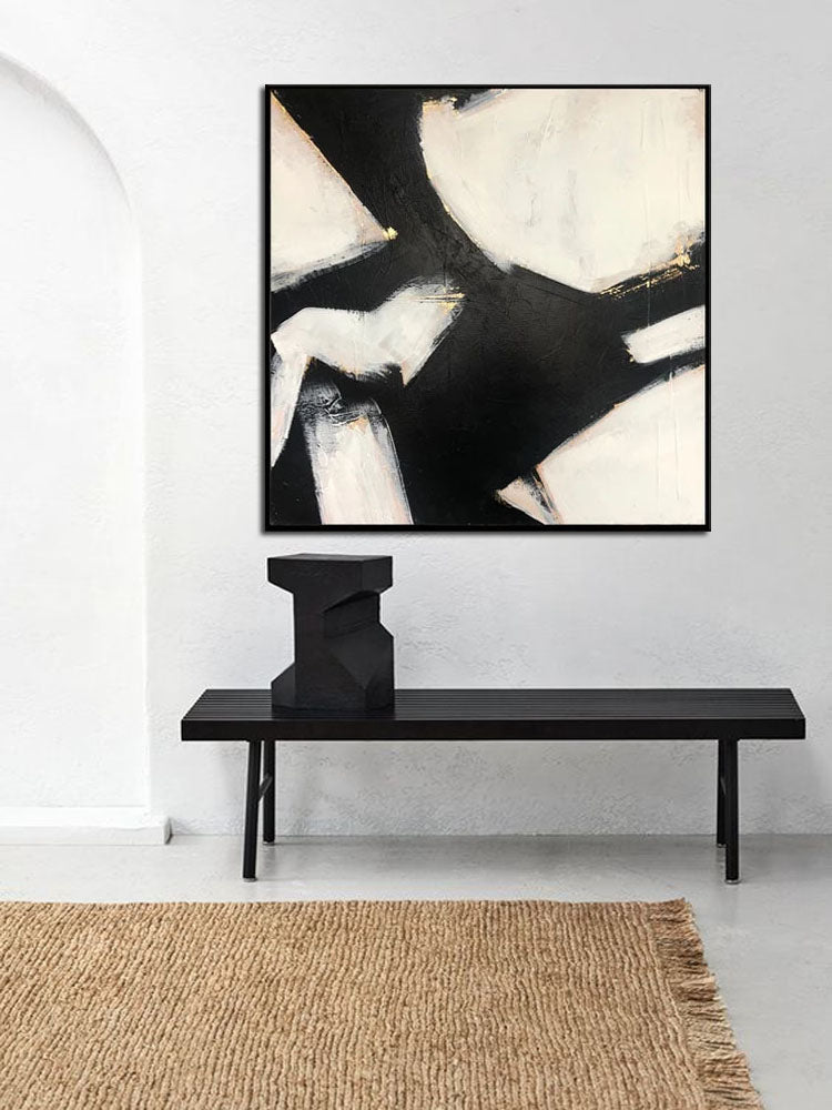 a black and white abstract painting on a white wall